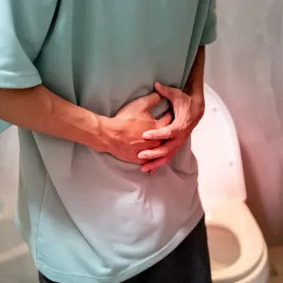 a man having stomach pain linked to constipation symptoms